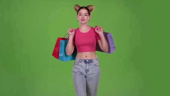 Teenager Goes Shopping with Bags in His Hands. Green Screen