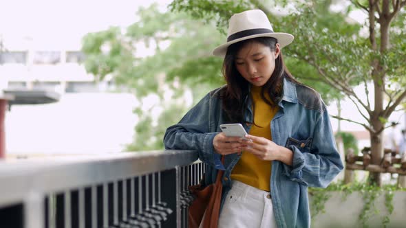 Young beautiful Asian woman talking on the phone.