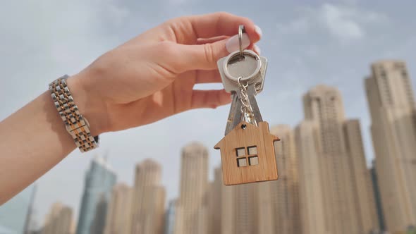 The Concept of Buying an Apartment in Dubai Skyscrapers, The Girl Holds in Her Hand the Keys To 