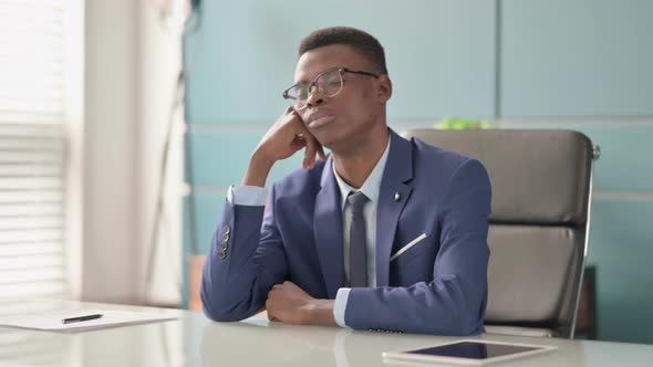 Sleepy Young African Businessman Taking Nap While Sitting in Office