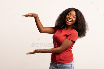 bject With Her Hands, Happy Excited Black Woman Measuring Something With Arms While Standing On White Background, Recommending New Item, Copy Space