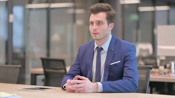 Pensive Businessman Thinking While Sitting in Office