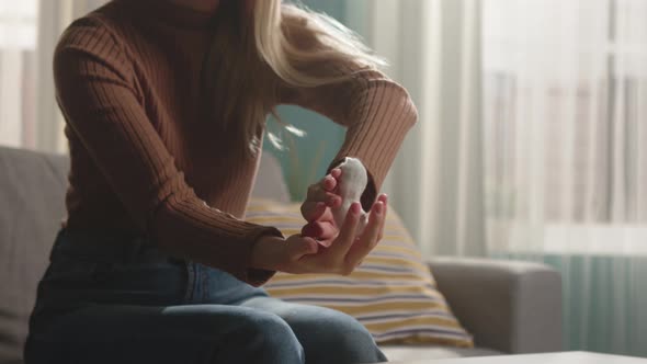 White Hamster Climbs Young Girl in Brown Sweater Sleeve