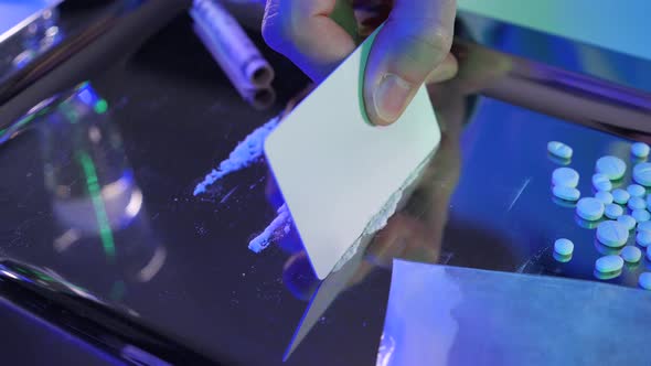 Man preparing line o toot of cocaine to sniff. Drug addict concept.