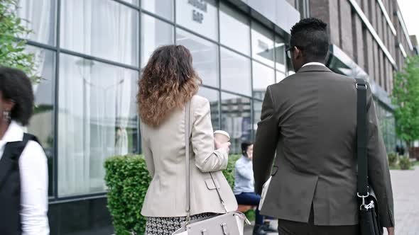 African Businessman Walking on the Street with Female Colleague