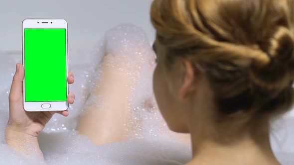 Female Holding Prekeyed Mobile Phone in Bathtub, Application for Business