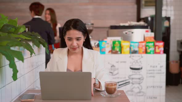 Cheerful business woman making yes gesture at remote workplace, celebrating the success business