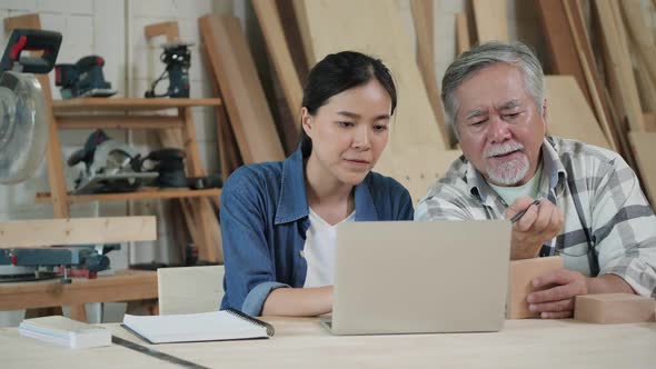 Senior man and woman working with wood