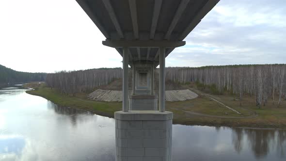 Flight Between the Supports of the Road Bridge Over the River