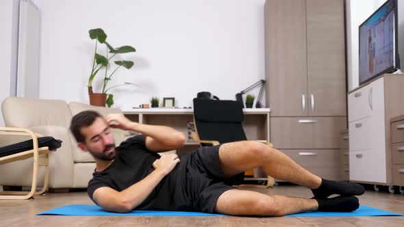 Man on His Rear Side Doing Exercises for the Abs