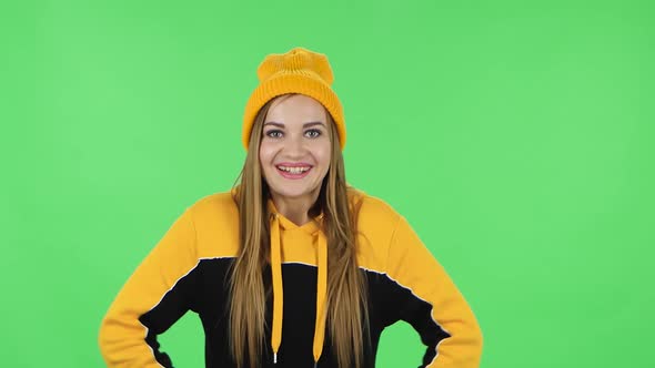 Portrait of Modern Girl in Yellow Hat in Anticipation of Worries, Then Disappointed and Upset. Green