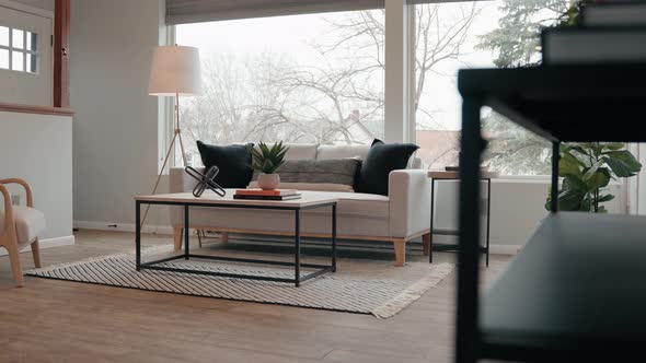 couch in the living room of a tiny home with a large window