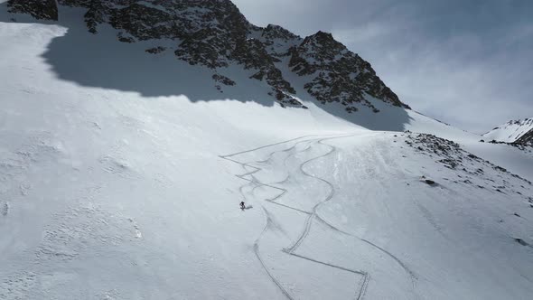 Professional Skier Ride Freeride Backcountry on a Snowy Slope on a Sunny Day