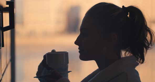 Side View of Woman in Bathrobe Preparing Delicious Aromatic Coffee in Coffee Machine