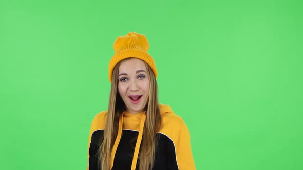 Portrait of Modern Girl in Yellow Hat Is Laughing