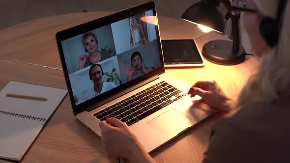 Woman Having Video Chat with Colleagues at Laptop in Office Closeup