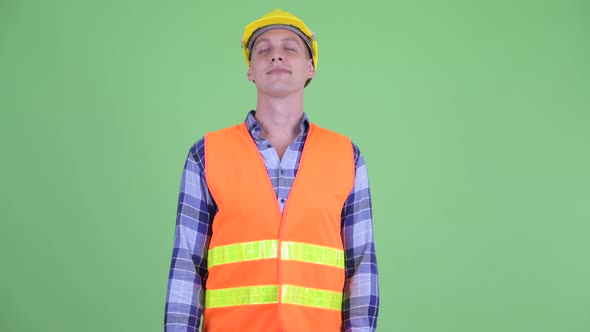 Happy Young Man Construction Worker Relaxing with Eyes Closed