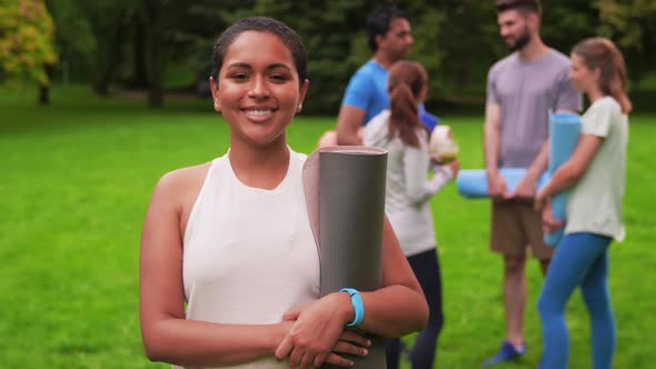 Smiling Woman with Yoga Mat Over Group of People