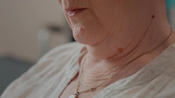 Senior Woman with Natural Wrinkles of Old Age Wearing Glamour Necklace