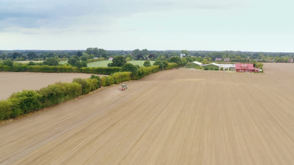 Aerial view of an agriculture field with tractor