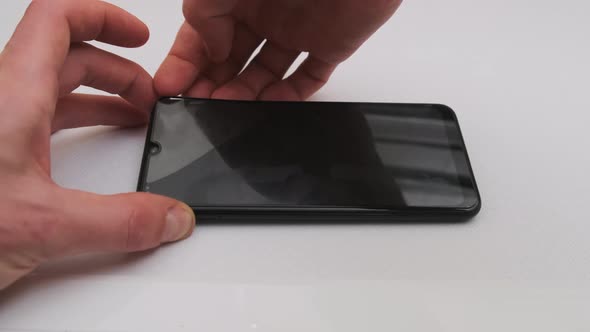 Sticking Protective Glass on the Smartphone Screen Change Cracked Safety Glass