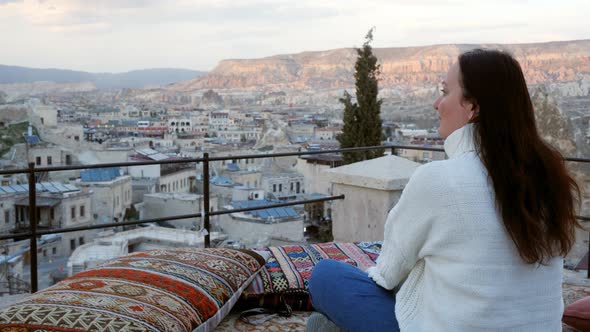 Woman Sitting on Terrace and Enjoying Sunset in Cappadocia