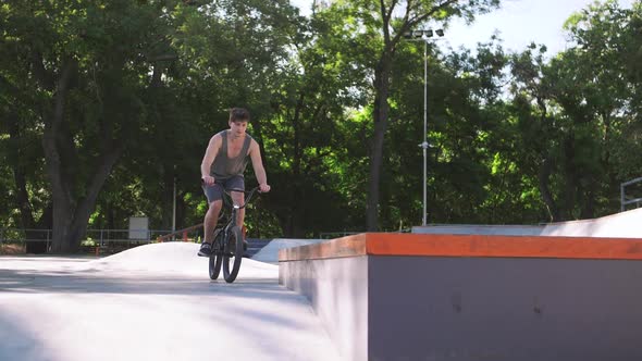 BMX Rider Doing Tricks in Cocncrete Skatepark Super Slow Motion