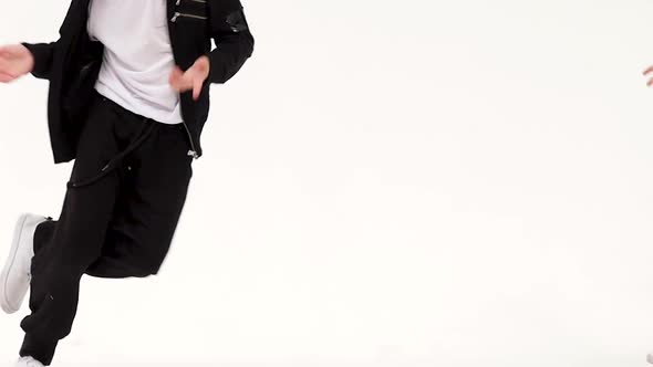Little Boy Is Dancing a Modern Dance on the White Background in Black Leather Jackets and Jeans