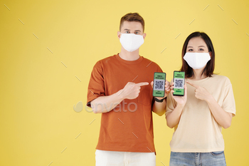 phones after getting vaccines against covid-19, isolated on yellow