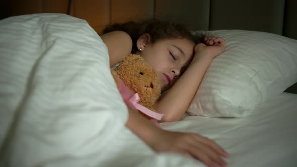 Sixyearold Girl Sleeps Sweetly in His Crib and Smiles in His Sleep