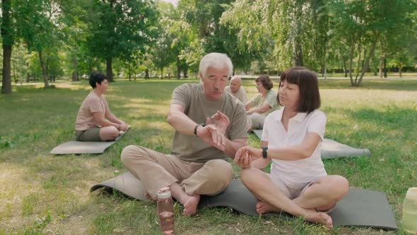 Two Seniors Using Their Smartwatches Outdoors