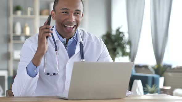 AfricanAmerican Doctor Talking on Phone with Patient