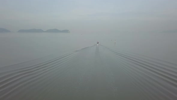 A boat move at sea in misty morning at Penang