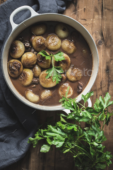 mushrooms and green herbs on wooden table