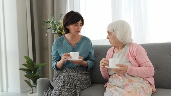 Grandmother and Granddaughter Drink Tea