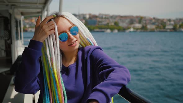 Attractive Young Girl Enjoys Boat Trip Sailing on a Ship Across Bosphorus