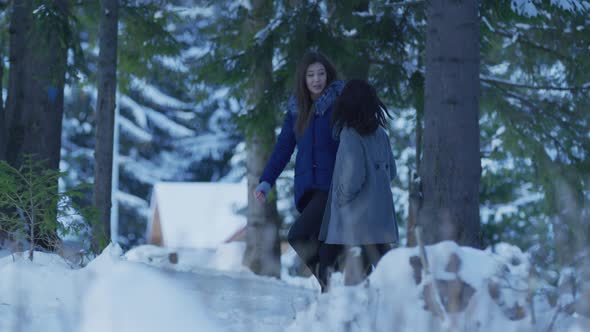 Two girls walking in the forest alt