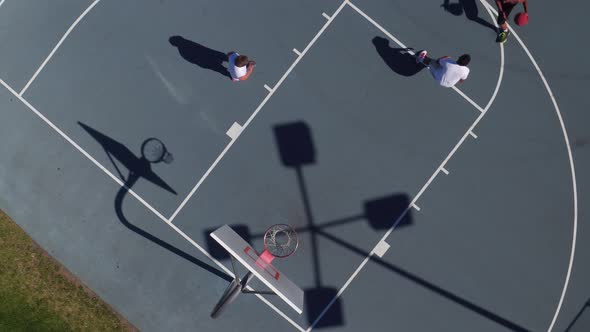 Friends playing basketball at park, overhead shot