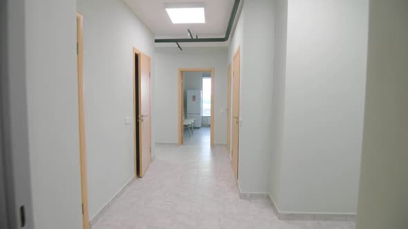 Empty Corridor with Open Doors to Offices in Public Building