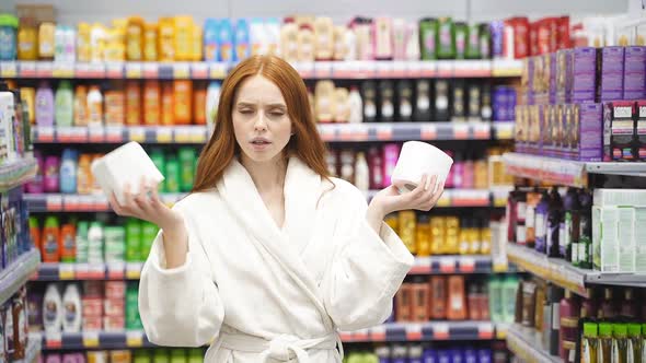 Thoughtful Caucasian Woman with Red Hair Choosing the Best Toilet Paper