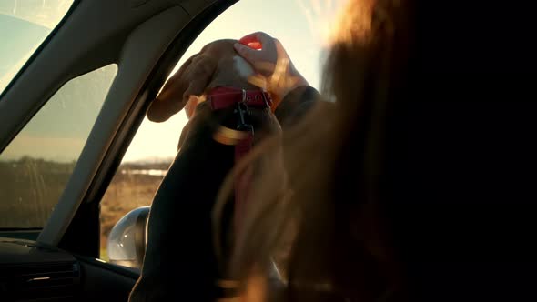 Beautiful Young Woman with Her Dog Traveling in a Car