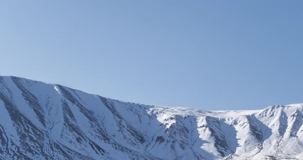 Timelapse of Sun Movement on Crystal Clear Sky Over Snow Mountain Top