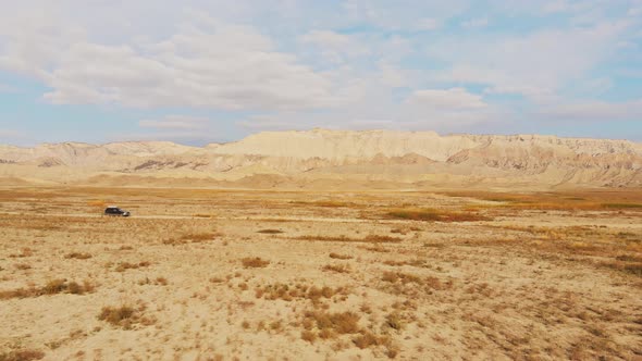 Low Angle Side Tracking Of 4x4 Vehicle In Scenic Landscape