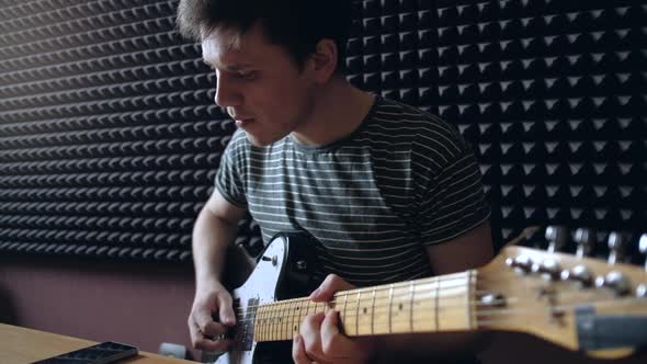 Musician Plays on Electro Guitar in the Studio