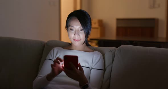 Woman Look at Mobile Phone and Sit on Sofa