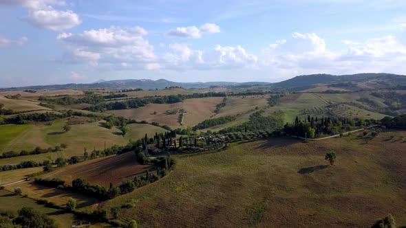 Large Italian villa on top of a hill in the Tuscan countryside near Florence, Aerial approach reveal