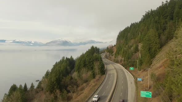 Aerial panoramic view of Sea to Sky Highway near Horseshoe Bay during a sunny winter evening before