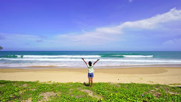 Happy young girl raise their hands up on the beach at patong beach Amazing sea tropical beach Summer