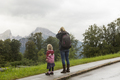 Rear view of mother and daughter hikers gazing at landscape from roadside, Berchtesgaden, Watzmann, - PhotoDune Item for Sale