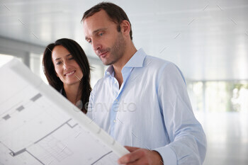 Architects looking at blue prints